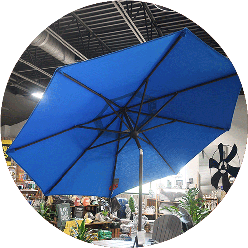 Seeing underneath of a bright blue umbrella, set at an angle.